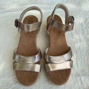 NWOT Tom’s Audrey gold wedge sandals.  Women’s size 8.5.